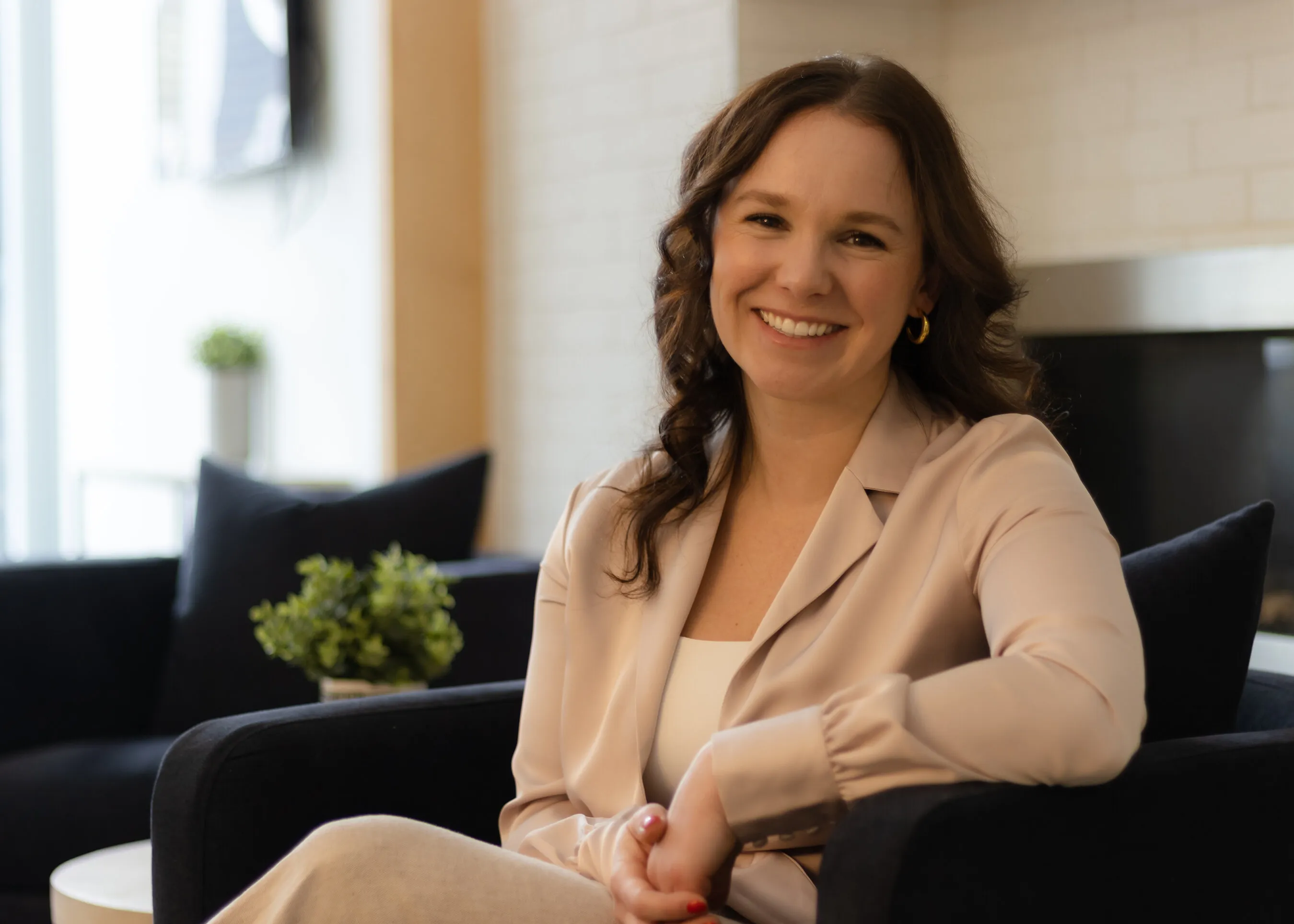 Victoria Landreville smiling while seated indoors.