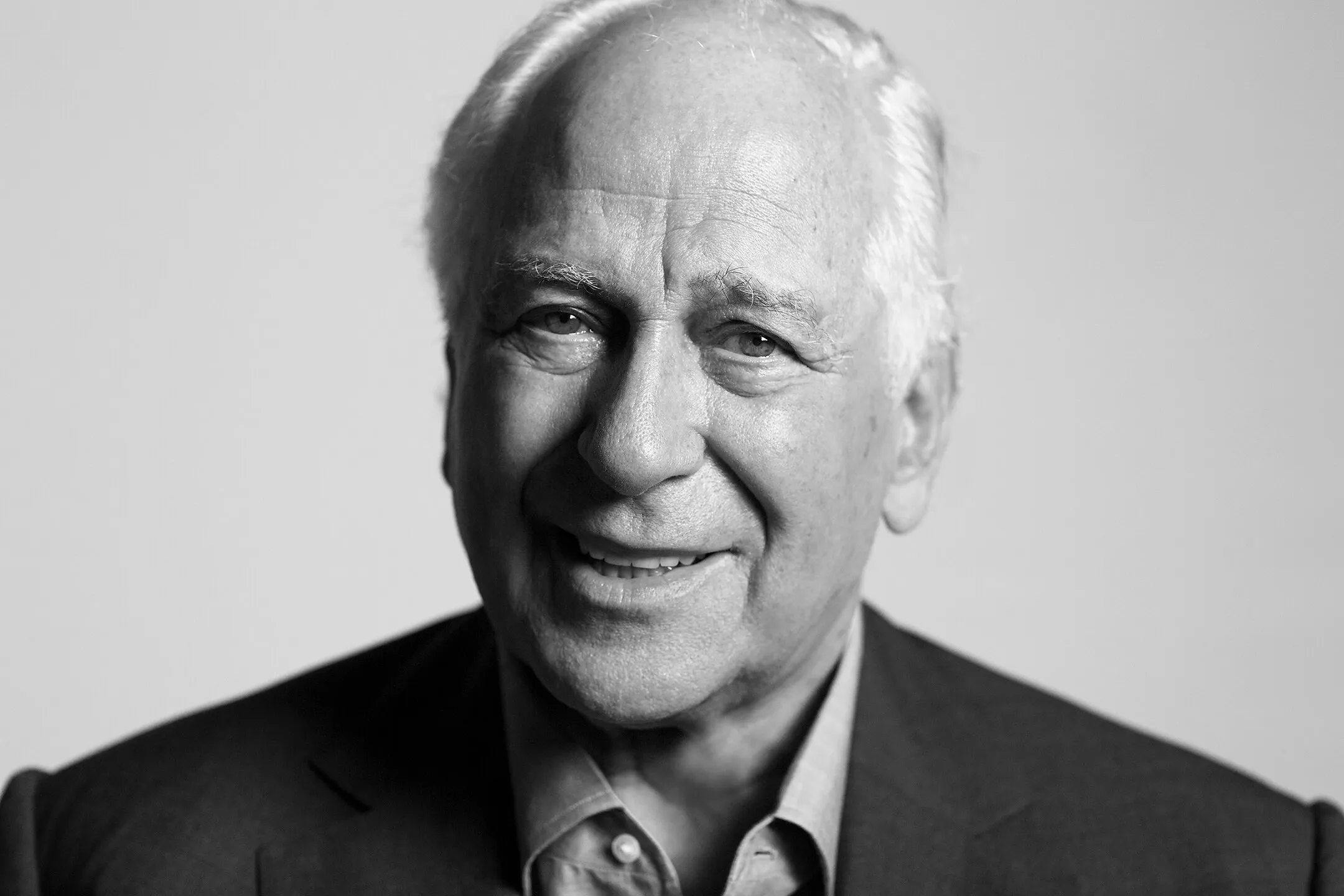 Sir Evelyn de Rothschild smiling in a suit.