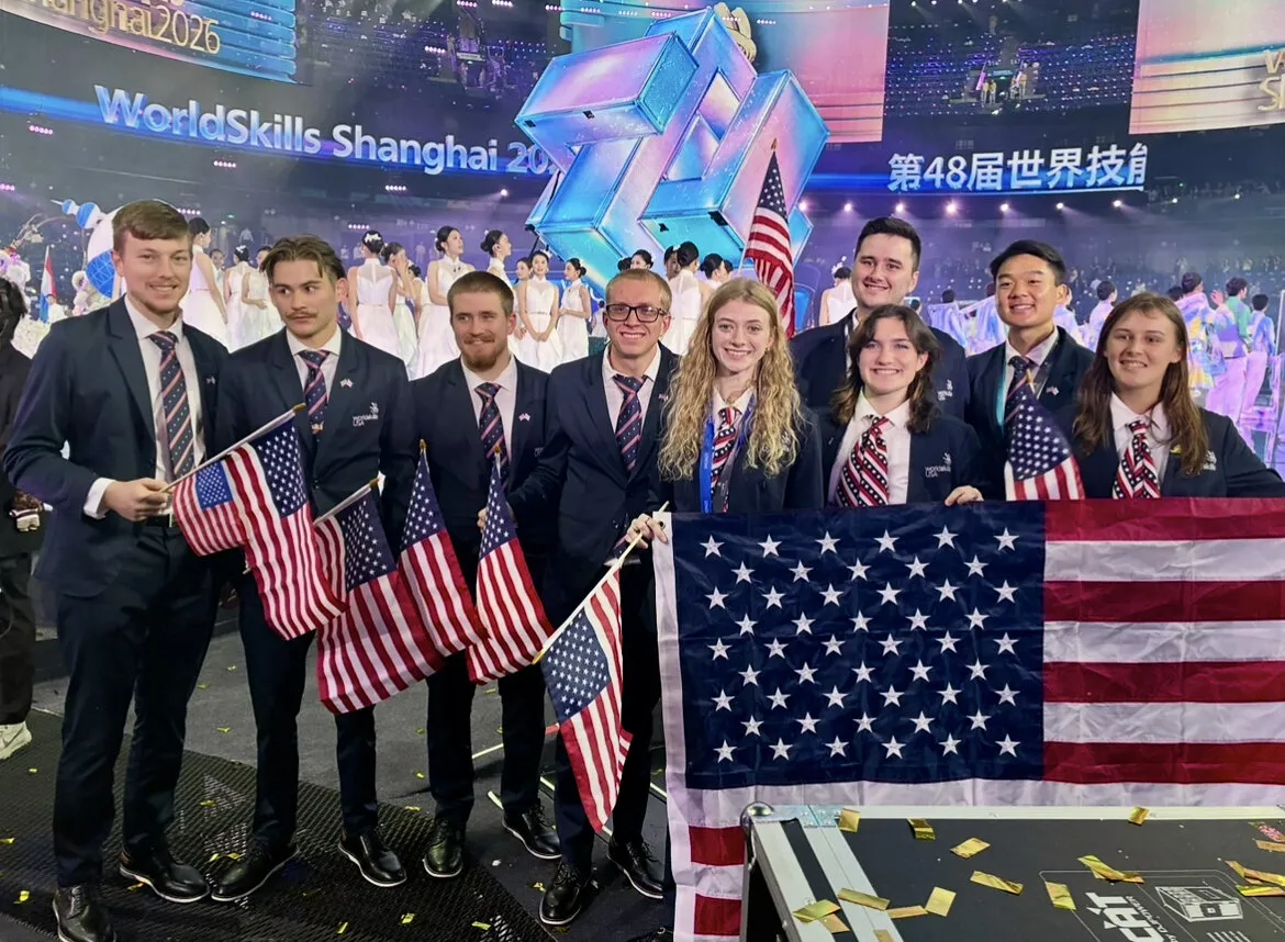 WorldSkills USA team members hold American flags at the closing ceremony of the WorldSkills Competition in Shanghai.