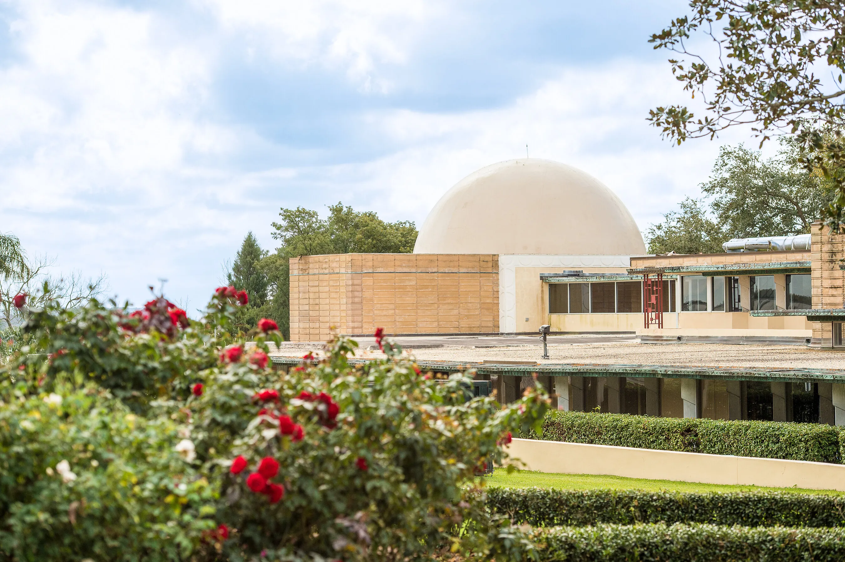 Exterior of the Polk Science Building planetarium at Florida Southern College, with gardens in front.